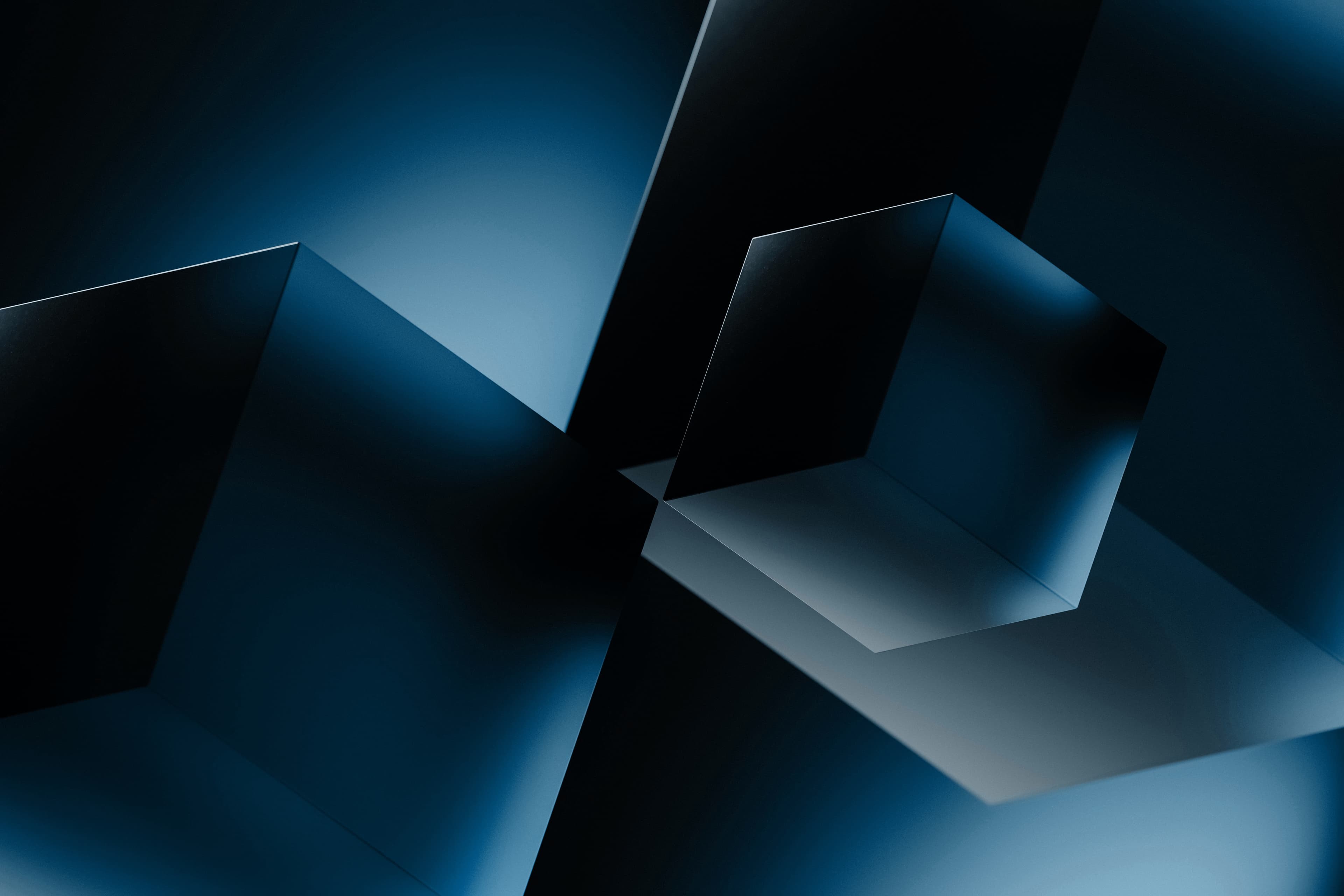 Abstract dark blue geometric composition featuring metallic cubes and sharp planes with soft highlights.